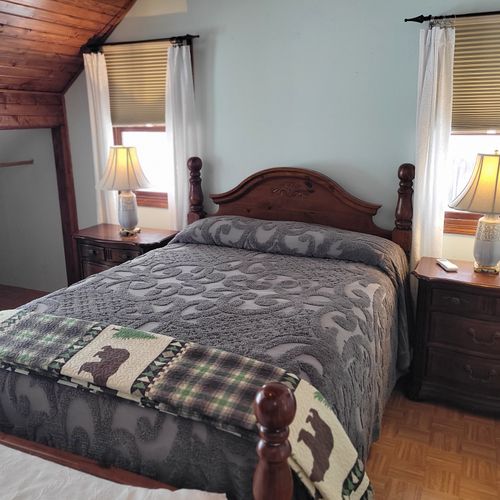 Bedroom #2 (second floor):  very large bedroom features a queen-size bed, walk-out deck, chair, 2 nightstands, 2 lamps, 2 dressers, ceiling fan, television, and private en suite full bathroom