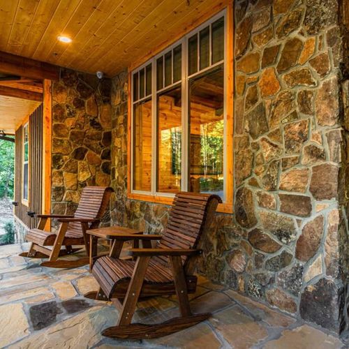 The front porch welcomes you with rocking chairs.