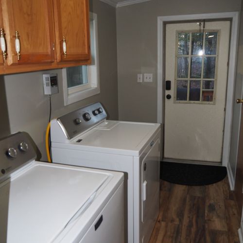 Laundry / mud room:  this features a new washer and dryer, additional closet space, and the side entrance to the house. The door to bathroom #2 can also be seen at the extreme right of the photo.