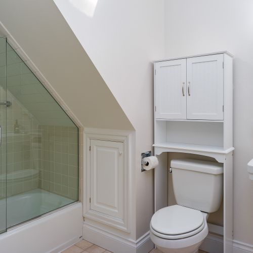 The Apartment full bathroom with a shower/tub combo and pedestal sink.
