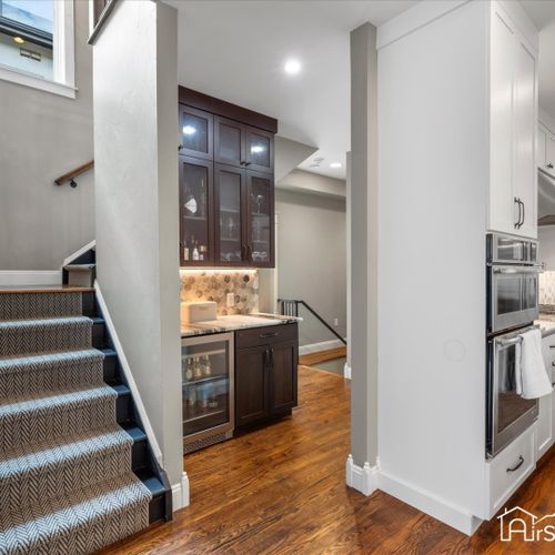 This chic separate bar area off the kitchen is perfect for mixing cocktails and entertaining guests in style.