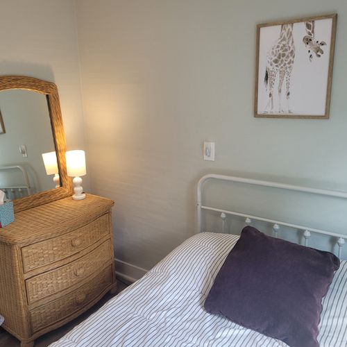 BEDROOM #2:  Features a full-size bed, dresser, lamp, mirror, and closet.