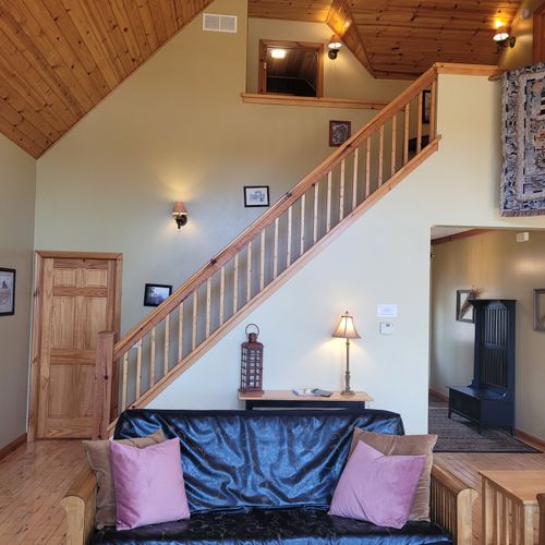 Living room:  gorgeous living room with 2 futons, an electric fireplace, and a lovely view of long lake!