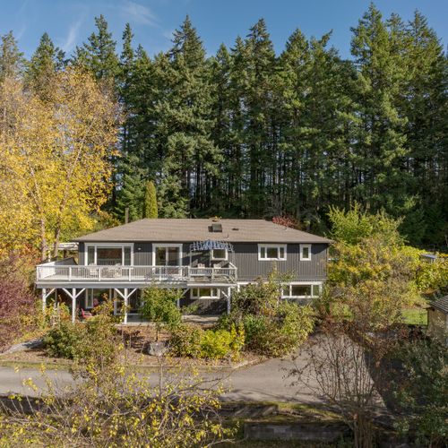 Soak up sunshine and forest views from the expansive wraparound deck—perfect for morning coffee, sunset drinks