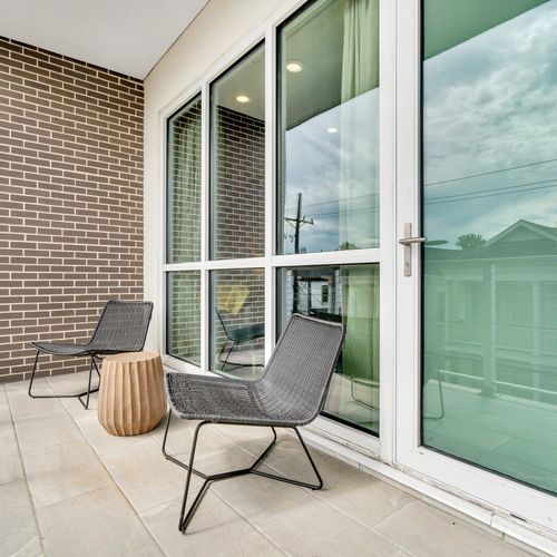 Private balcony with cozy seating and charming neighborhood views.