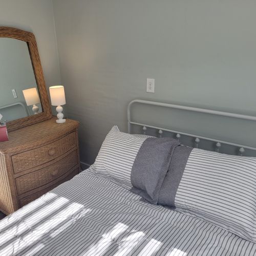 Bedroom #2:  features a full-size bed, dresser, mirror, and closet.