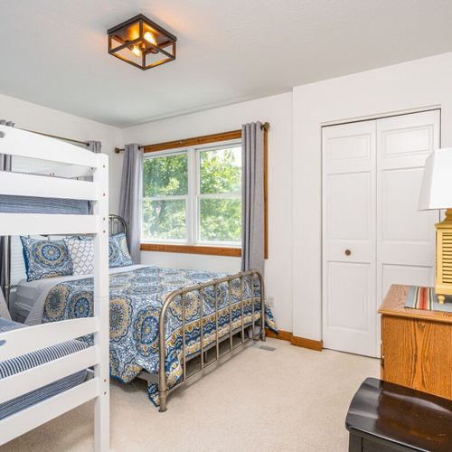 Bedroom #4 (second floor):  features a full-size bed, bunk bed, dresser, chair, and a nice view of betsie lake.