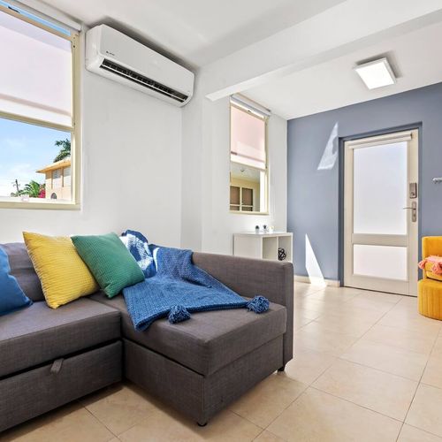 Kick back and watch your favorite shows. The living room features a large smart TV and stylish decor for ultimate relaxation and entertainment.