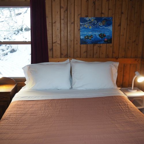 Bedroom #1 (main floor):  features a queen-size bed, nightstands with lamps, a dresser and a closet.