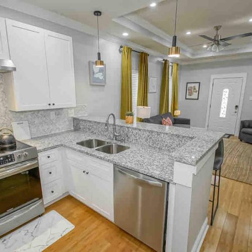 Fully stocked kitchen w/ dinnerware, glasses, & utensils — ready for any meal.