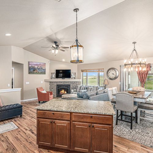 A modern kitchen with stainless steel appliances and a sleek granite countertop, perfect for preparing your favorite meals, just like at home.