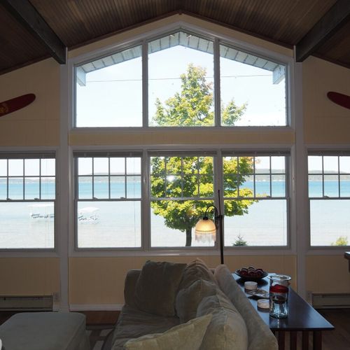 Upstairs living room:  the home has a beautiful living room with comfy furniture, a television with live streaming via roku, a ceiling fan, and spectacular views of crystal lake. (note that the fireplace is not for guest usage. )