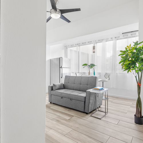 Natural light floods in, illuminating the simplicity of this modern living room.