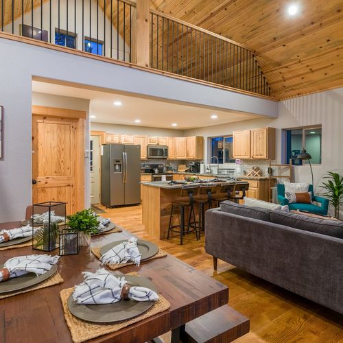 The dining area provides a glimpse of the living room, where a mod-farmhouse table seats up to six.