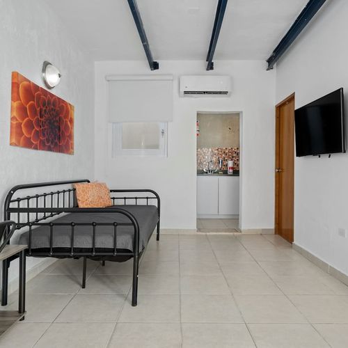 The plush bed and wall-mounted flat-screen TV make this space perfect for unwinding.