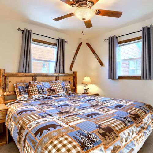 - spacious king bed wrapped in playful bear and moose patchwork bedding
- vintage skis, moose lamps, and natural wood details make this room unforgettable
- surrounded by windows, it’s the perfect cozy nook for relaxing after a day outdoors