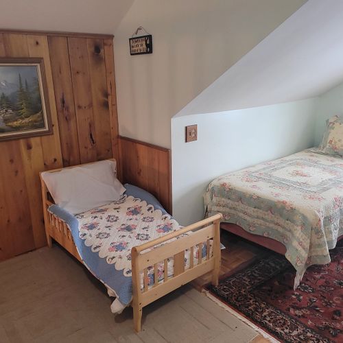 Loft area:  outside of the upstairs bedroom there is a cute loft area with 2 single beds, a small child's bed, and a chair.