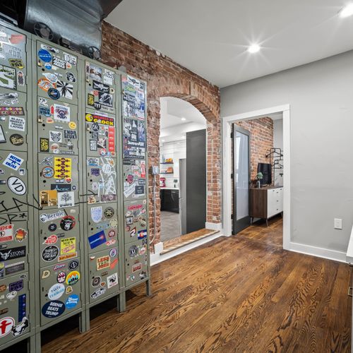 Entry hallway with hardwood floors and access to kitchen and living areas.