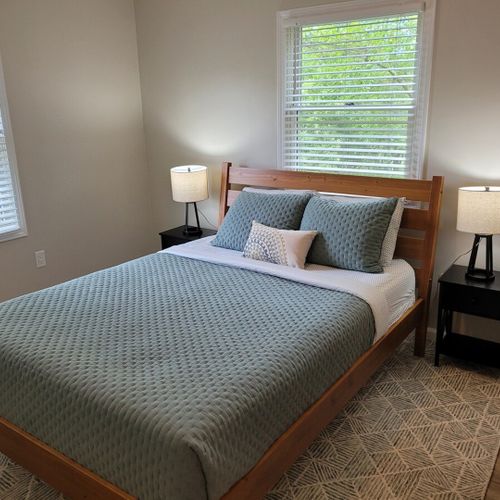 Bedroom #2:  bedroom #2 features a queen-size bed, ceiling fan, dresser, matching nightstands with lamps, and a closet.