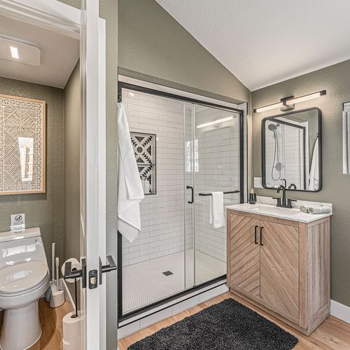 - freshen up in this spa inspired ensuite with glass shower and wood vanity cabinet
- crisp white tile and modern black fixtures bring a sleek and calming vibe
- thoughtful design blends comfort and style for a relaxing retreat