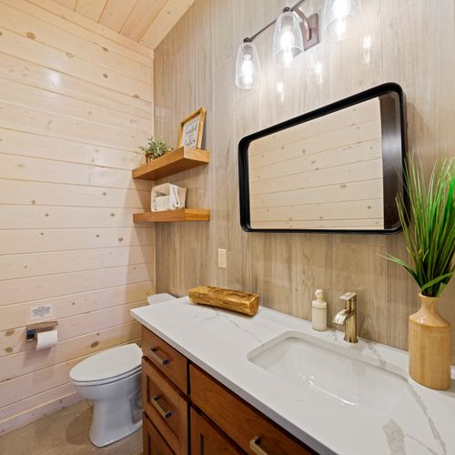 Conveniently located just off the game room, this stylish half bath keeps everyone comfortable and refreshed throughout the day—no trips upstairs required.