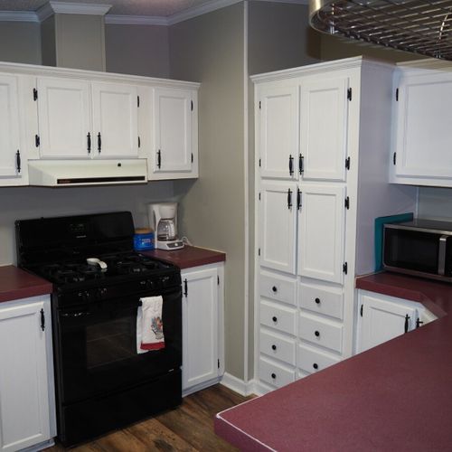 An overview of the kitchen, which includes a gas range (stovetop and oven), dishwasher, refrigerator, sink, microwave, coffee maker, toaster, and lots of counter and cabinet space.