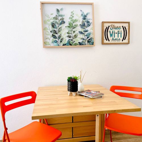 Gather around our welcoming dining table, adorned with captivating wall art – the perfect spot for memorable meals, lively conversations, and planning your next adventure.