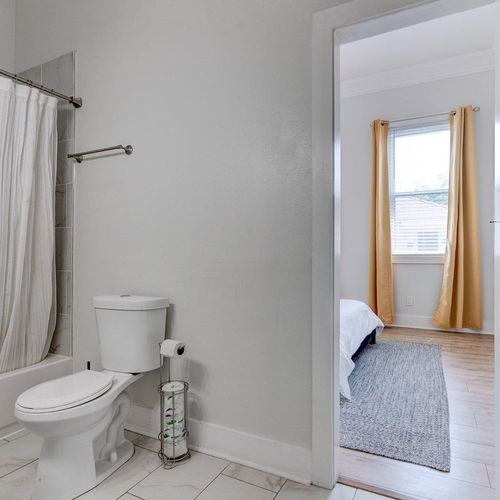 Clean, well-lit bathroom w/ tub & all the essentials you need.