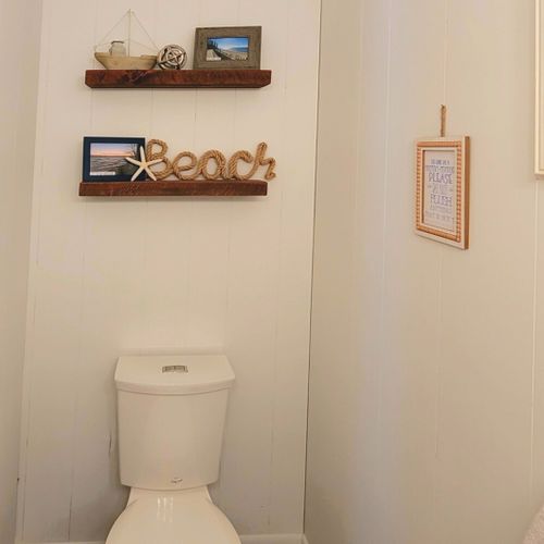 Half-bath:  conveniently entered into from the living room, there is a common half-bath with a sink, vanity, mirror, and toilet.