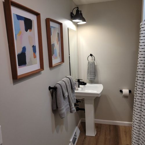 Bathroom #2:  second full bathroom that also serves as the laundry room having a stacked washer and dryer in it.