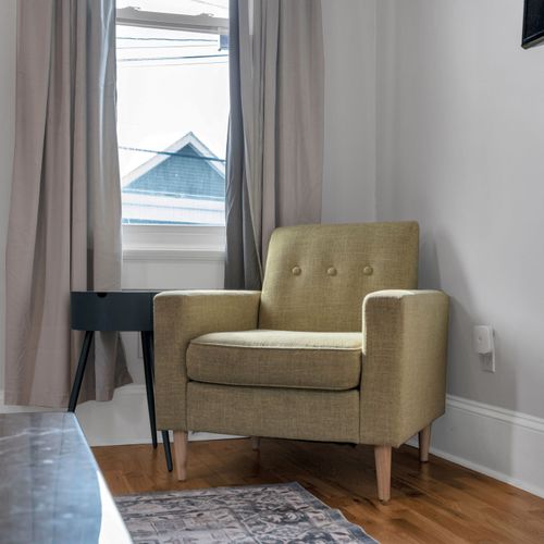 Cozy sitting area w/ a cushioned armchair — a quiet corner to unwind.