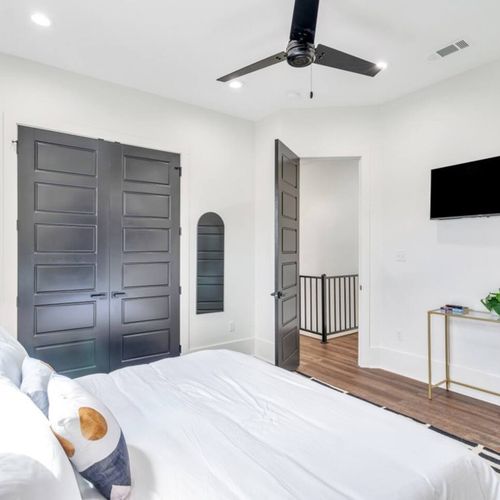 Upstairs king bedroom w/ en-suite bath & bold dark door for a moody, stylish feel.