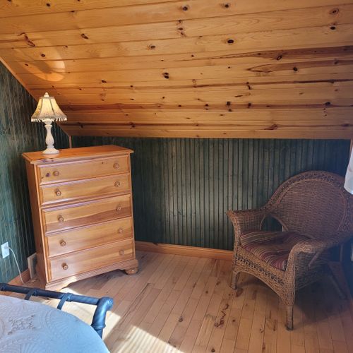 Bedroom #2 (upper level):  features a queen-size bed, chair, dresser, closet, ceiling fan, nightstands, and lamp