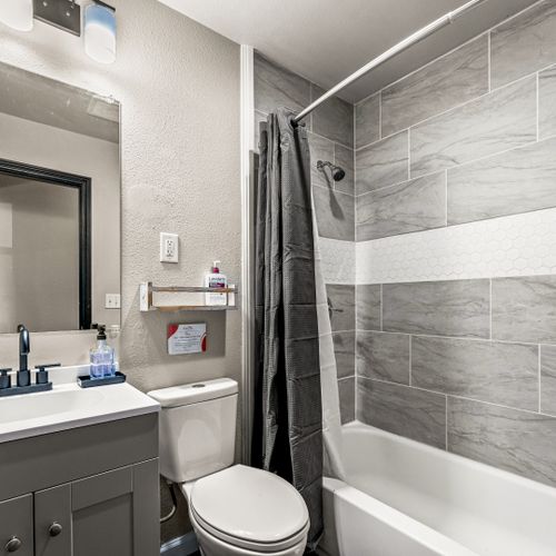Modern calm with a deep tub and soft neutral palette.