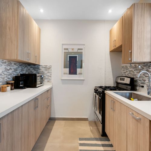 A bright and clean kitchen with a lot of counter space.