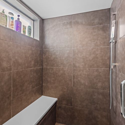 Essential toiletries provided in the main bathroom’s walk-in shower.