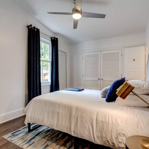 Inviting queen bed dressed in crisp linens — rest easy after a full day out.