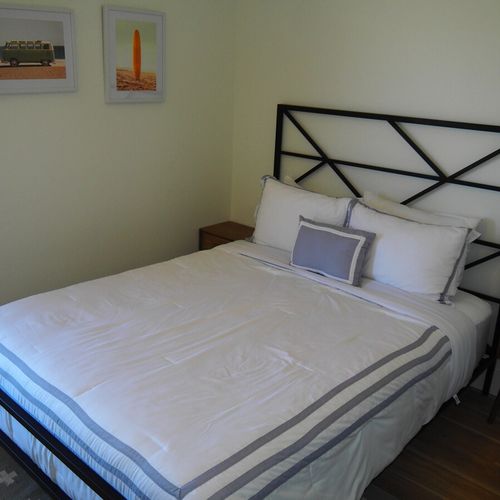 Bedroom #2:  features a queen-size bed, nightstands, desk, and a large wall closet.