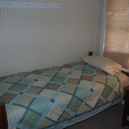 Bedroom #2:  features two twin beds, a nightstand, lamp, dresser, mirror, and closet.