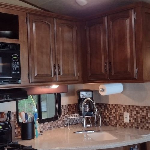 Kitchen:  the home has a cute little kitchen with a refrigerator, sink, counter, stove, oven, and microwave. There is also a collection of cooking and dining utensils provided.