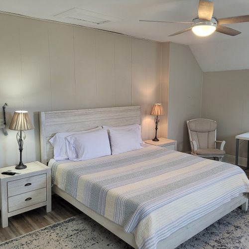 Bedroom #2 (second floor):  huge upstairs bedroom with a king-size bed, nightstands, lamps, 2 dressers, private television with live streaming, mini-split a/c unit, ceiling fan, desk with chair, comfy chairs, and a closet.