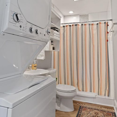 First floor bathroom w/ washer & dryer conveniently tucked in.