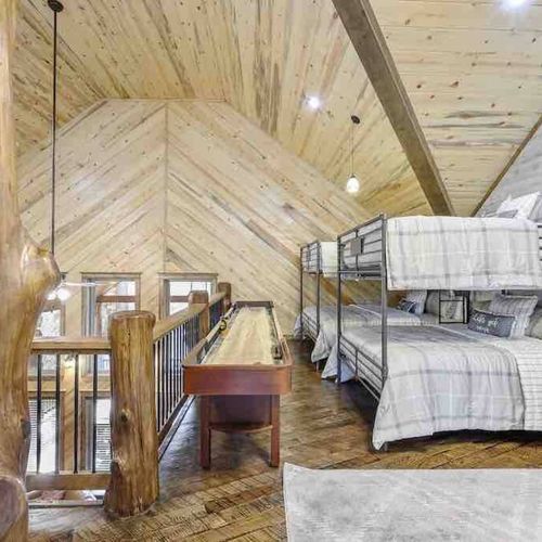 The upstairs loft offers additional sleeping space w/ 4 Queen beds, bunk style.
