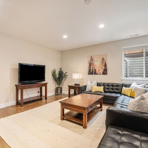 Kick back and relax in our basement recreation area, featuring a spacious leather sectional for ultimate comfort!