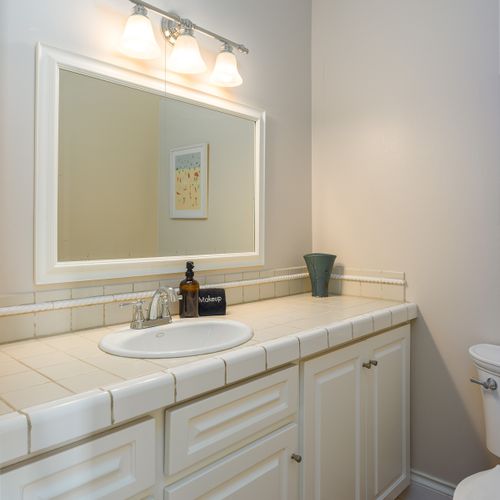 Powder room conveniently located right inside from the back patio, kitchen and laundry area.