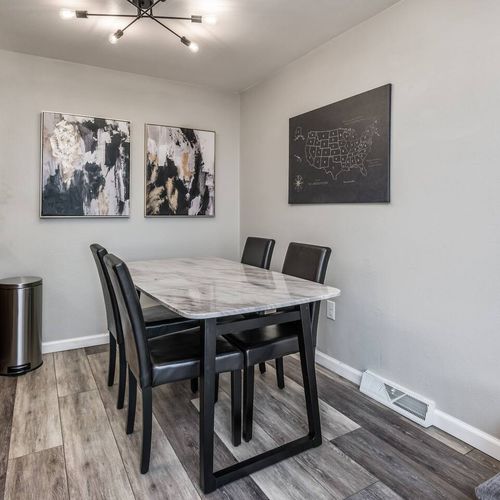 - elegant marble dining table with seating for four and stylish black chairs
- wall mounted us map and abstract prints add artistic flair to the space
- perfect for enjoying meals working remotely or hosting casual dinners