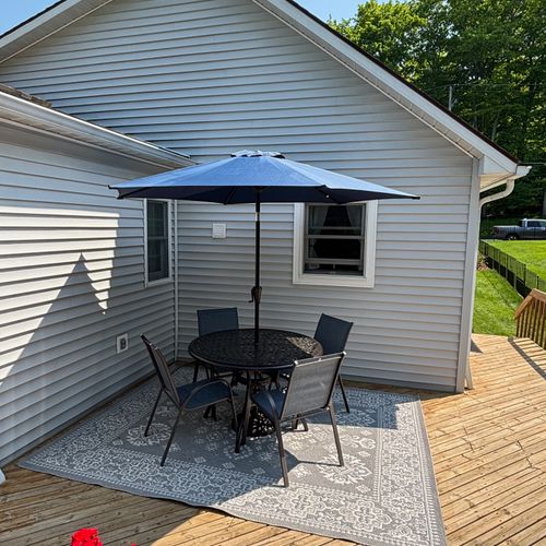 EXTERIOR:  The outdoor dining furniture on the backyard deck.