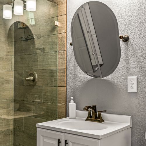 A sleek walk-in shower with glass doors, perfect for a refreshing, spa-like experience after a busy day.