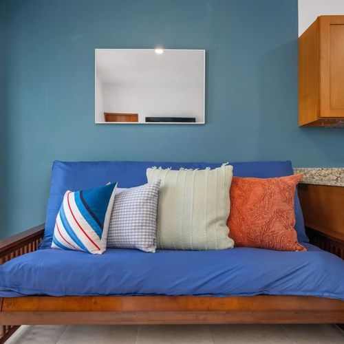 Step into a cozy, modern living space featuring a vibrant blue sofa.