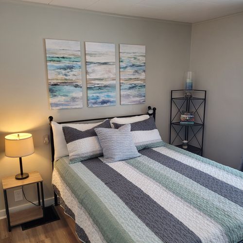 Bedroom #2:  features a queen-size bed, ceiling fan, nightstand, lamp, large closet, and 2 chairs.